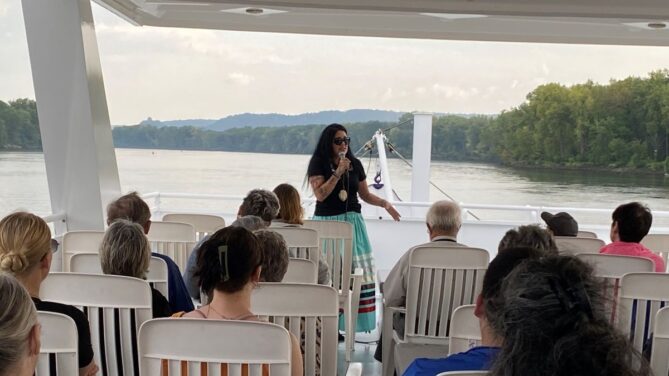 Nicky Buck speaking on Winona County Historical Society History on the River Cruise 2023