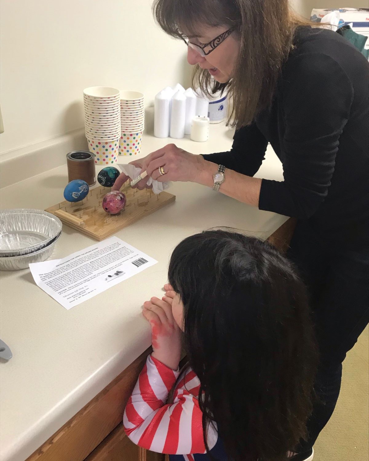 Volunteer helping at Winona County History Center Pisanki egg coloring class